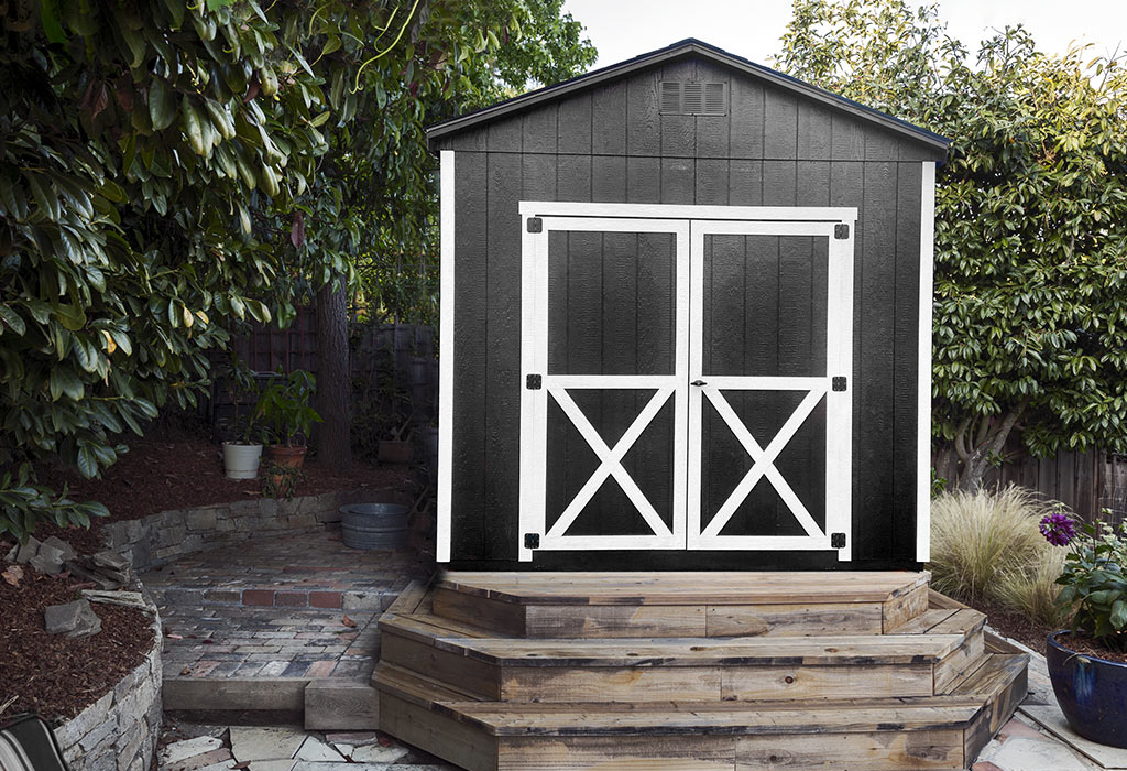 Black a frame style wood shed with white trim