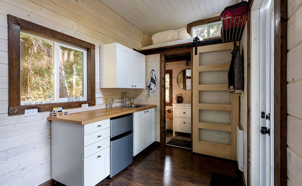 Interior kitchen and loft bed of tiny home
