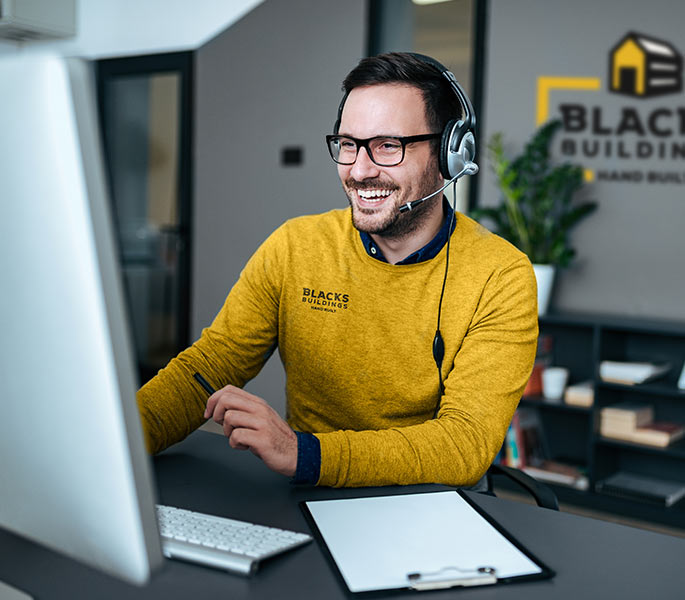 Blacks building's customer service worker smiling on the phone